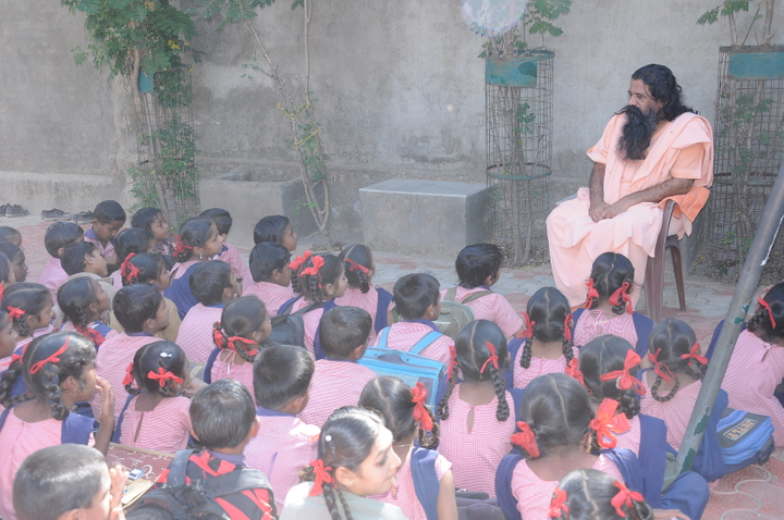 primary children sitting outside bapu