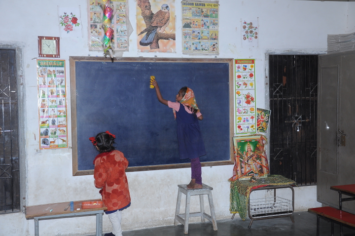 girl writing on blackboard
